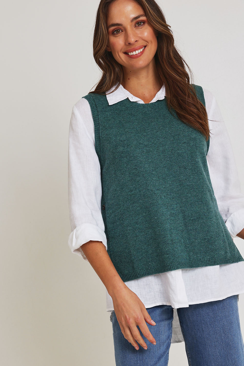 Model Madeline wearing size S of the Mitos Vest in colour Darksea (Green), from the front, cropped image