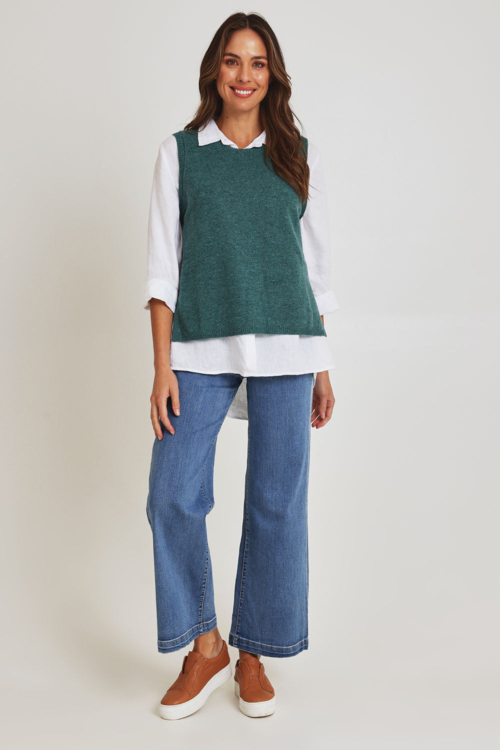 Model Madeline wearing size S of the Mitos Vest in colour Darksea (Green), from the front, showing the whole outfit