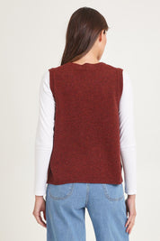 Model Madeline wearing size S of the Mitos Vest in colour Spice, from the back