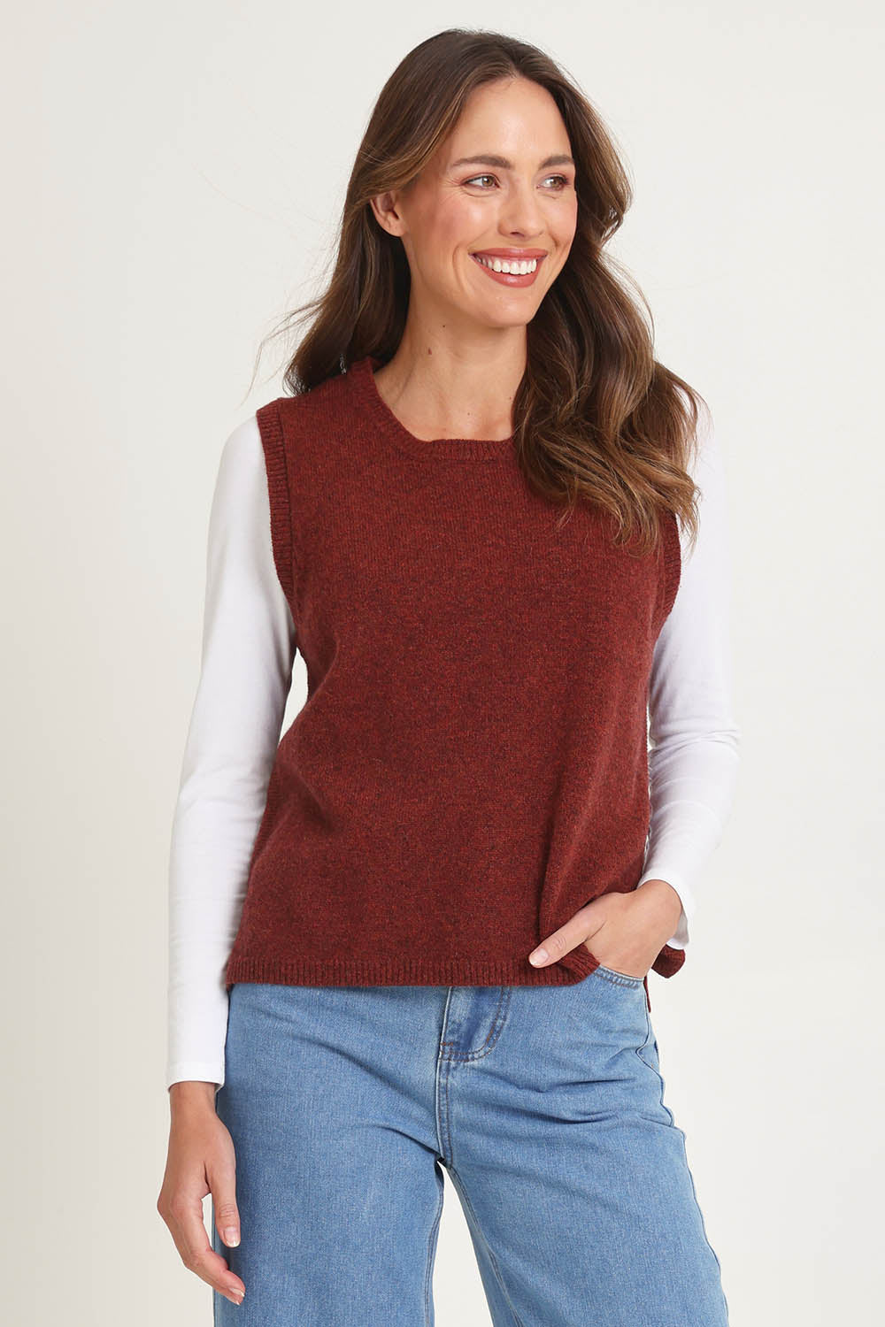 Model Madeline wearing size S of the Mitos Vest in colour Spice, from the front, cropped image