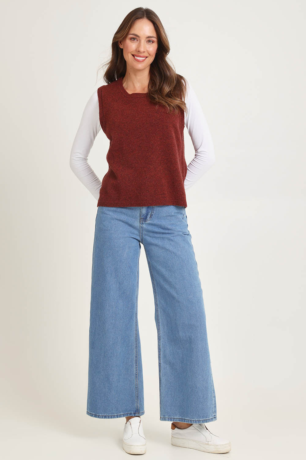 Model Madeline wearing size S of the Mitos Vest in colour Spice, from the front, showing the whole outfit
