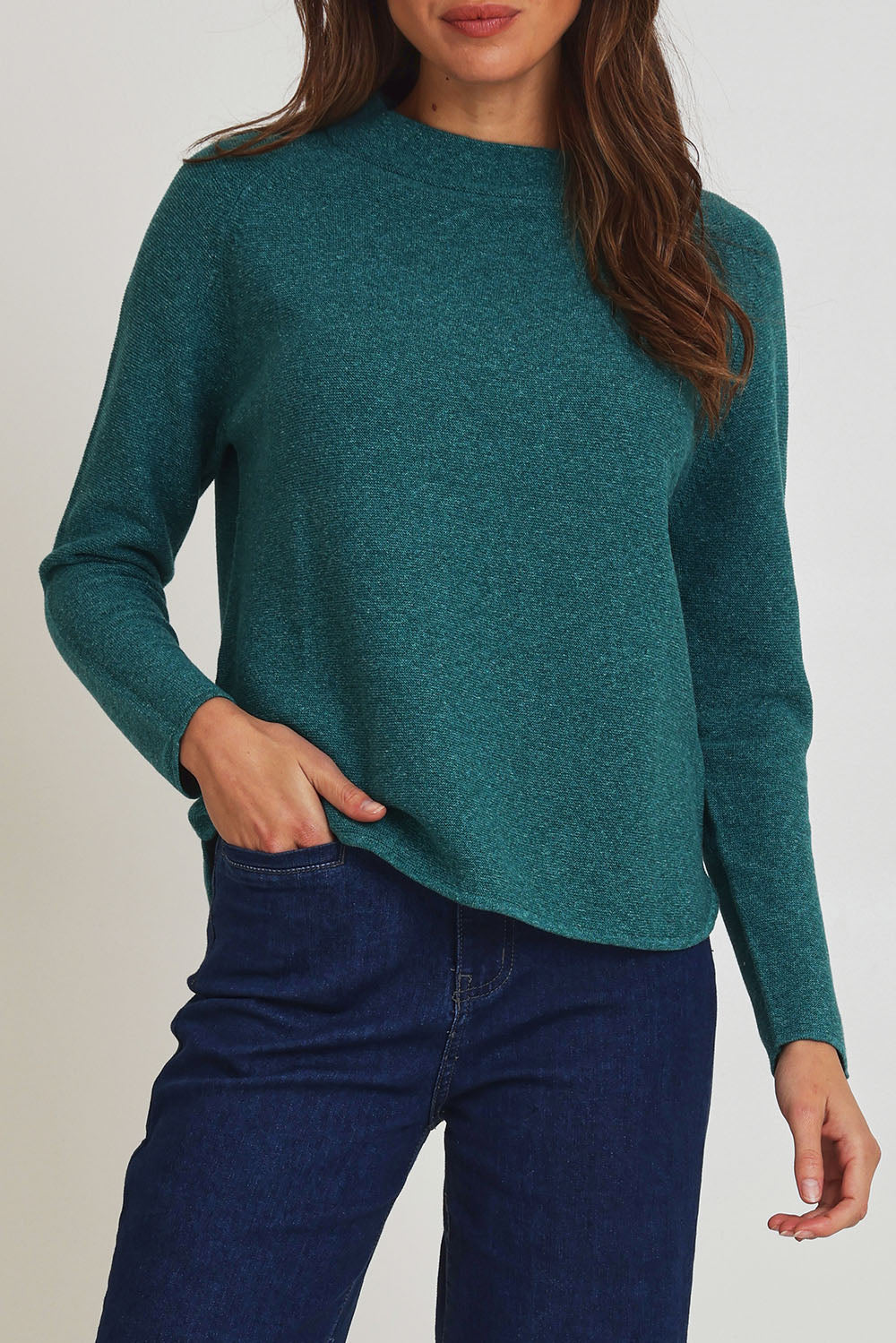 Model Madeline wearing size S of the Mosque Sweater in colour Sea (Green), from the front, cropped image