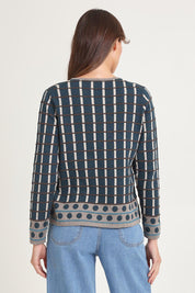 Model Madeline wearing size S of the Oda Organic Cotton Sweater in colour Darkaqua (Green), from the back