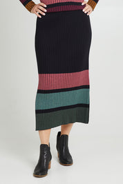 Model Luisa wearing size S of the Paula Reversible Skirt in colour Black (Black), from the front, cropped image