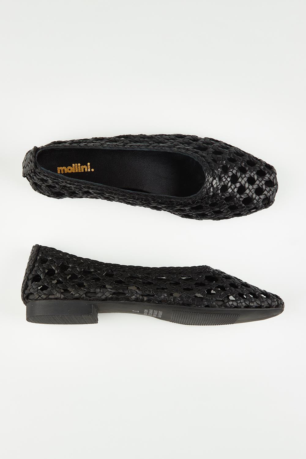 A model wearing size 37 of the Doetta Leather Woven Flat in colour Black (Black), from the front, showing the whole outfit