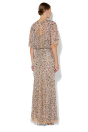 A model wearing the Mimi Hand Beaded Gown in colour Mink, from the back