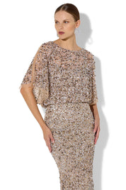 A model wearing the Mimi Hand Beaded Gown in colour Mink, from the front, cropped image