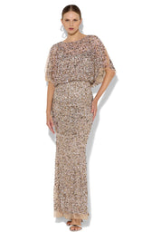 A model wearing the Mimi Hand Beaded Gown in colour Mink, from the front, showing the whole outfit