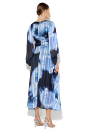 A model wearing the Salina Printed Maxi Dress in colour Navysky (Blue), from the back