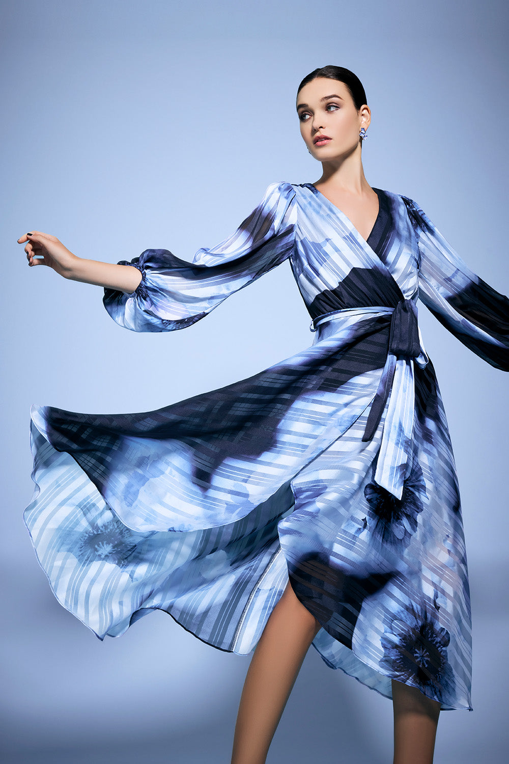 A model wearing the Salina Printed Maxi Dress in colour Navysky (Blue), from the front, showing the whole outfit