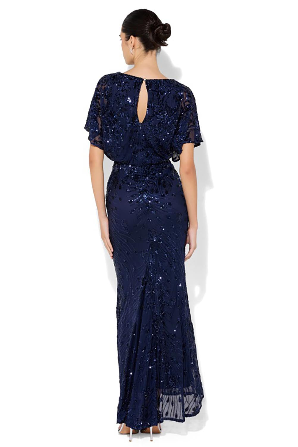 A model wearing the Aria Sequin Maxi Gown in colour Navy (Blue), from the back