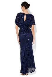 A model wearing the Aria Sequin Maxi Gown in colour Navy (Blue), from the back