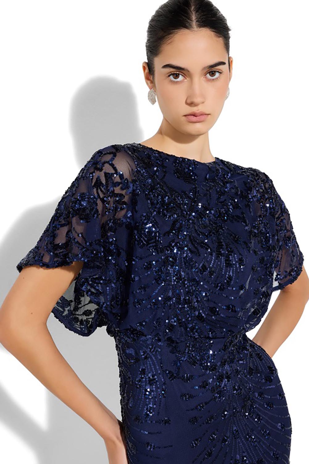 A model wearing the Aria Sequin Maxi Gown in colour Navy (Blue), from the front, cropped image