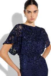A model wearing the Aria Sequin Maxi Gown in colour Navy (Blue), from the front, cropped image