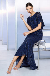 A model wearing the Aria Sequin Maxi Gown in colour Navy (Blue), from the front, showing the whole outfit