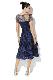 A model wearing the Reece Embroidered Cocktail Dress in colour Navy (Blue), from the back