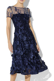 A model wearing the Reece Embroidered Cocktail Dress in colour Navy (Blue), from the front, cropped image