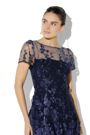 A model wearing the Reece Embroidered Cocktail Dress in colour Navy (Blue), from the front, cropped image