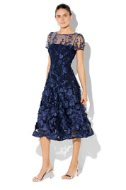 A model wearing the Reece Embroidered Cocktail Dress in colour Navy (Blue), from the front, showing the whole outfit