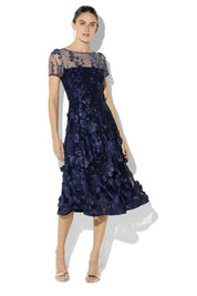 A model wearing the Reece Embroidered Cocktail Dress in colour Navy (Blue), from the front, showing the whole outfit