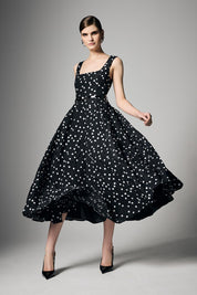 A model wearing the Ascot Dot Dress in colour Blkwhtdot (Black), from the front, showing the whole outfit