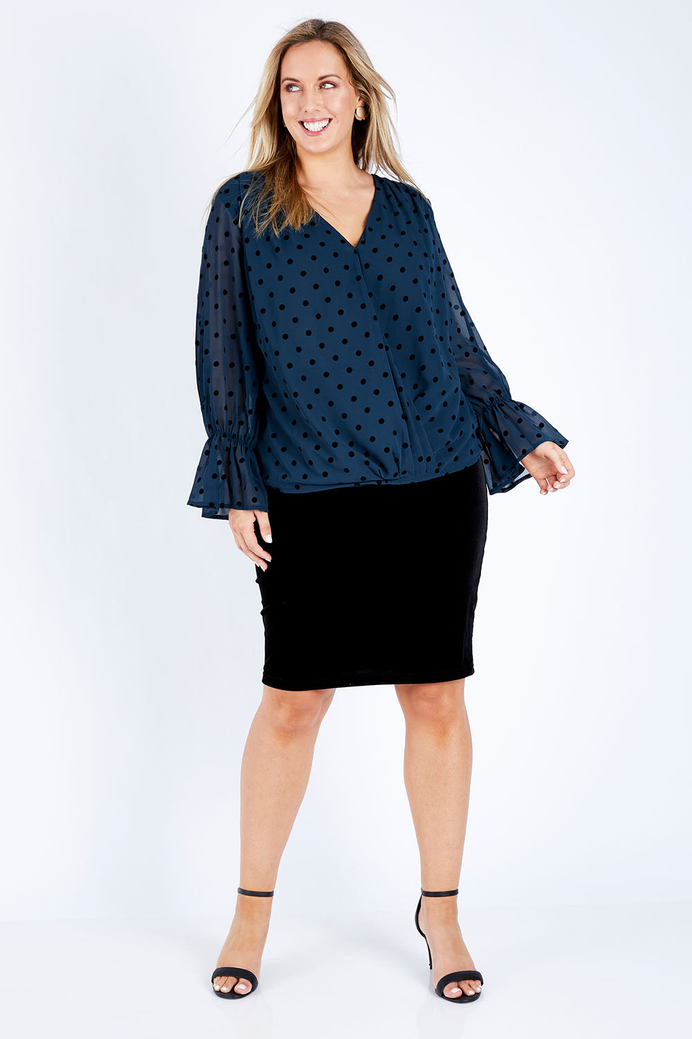 Model Jess wearing size 14 of the Roanna Skirt in colour Black (Black), from the front, showing the whole outfit