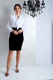 Model Madeline wearing size 10 of the Roanna Skirt in colour Black (Black), from the front, showing the whole outfit