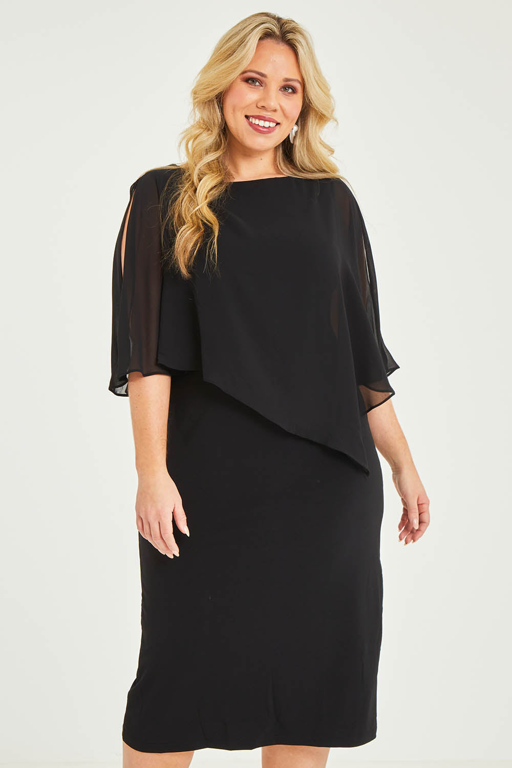 Model Katie wearing size 16 of the Cassandra Dress in colour Black (Black), from the front, cropped image