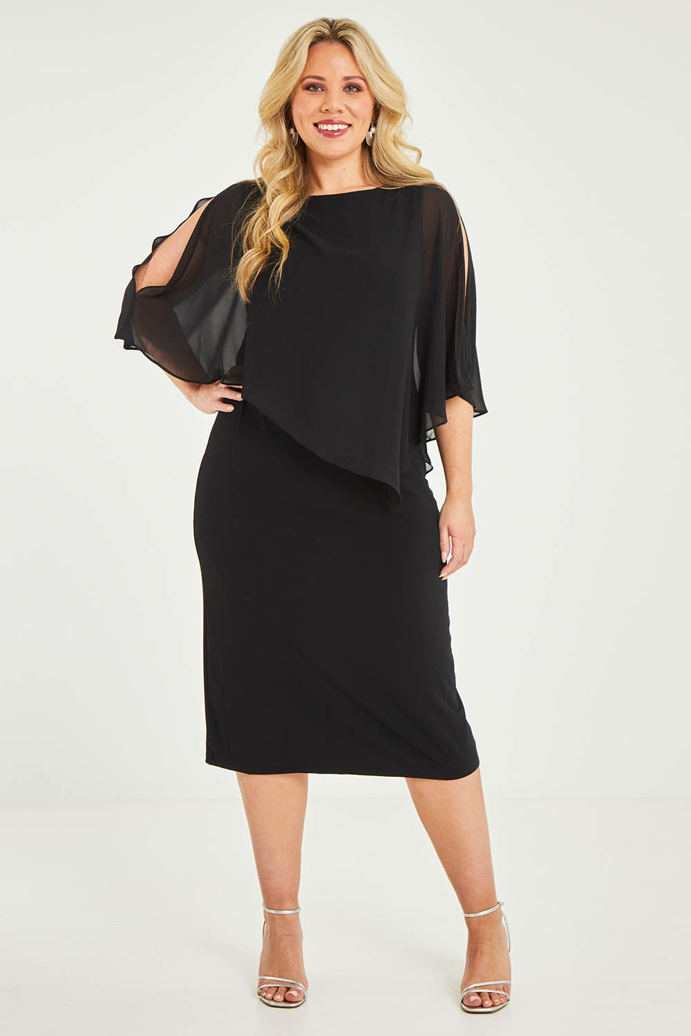 Model Katie wearing size 16 of the Cassandra Dress in colour Black (Black), from the front, showing the whole outfit