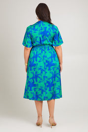 Model Poppy wearing size 16 of the Alanah Wrap Dress in colour Bahamas (Green), from the back