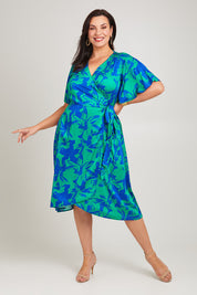 Model Poppy wearing size 16 of the Alanah Wrap Dress in colour Bahamas (Green), from the front, showing the whole outfit