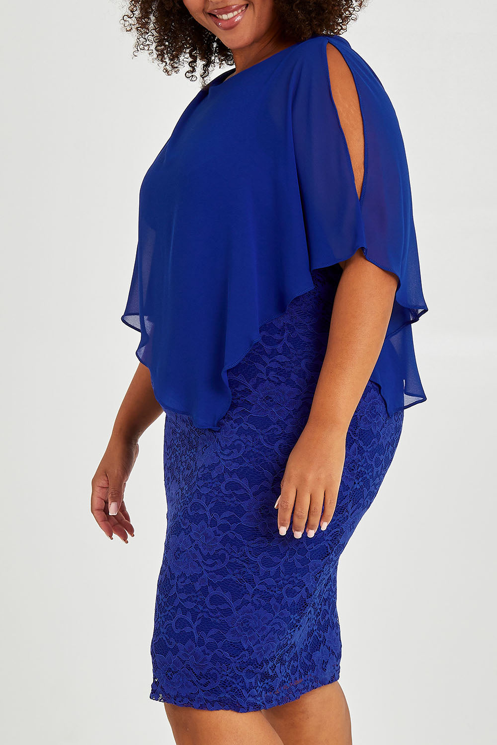 Model Alexis wearing size 16 of the Marnie Dress in colour Sapphire (Blue), from the front, cropped image
