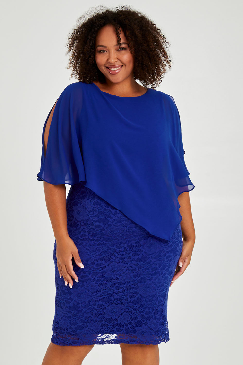 Model Alexis wearing size 16 of the Marnie Dress in colour Sapphire (Blue), from the front, cropped image