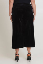 Model Chanel wearing size 16 of the Samantha Velvet Culottes in colour Black (Black), from the back