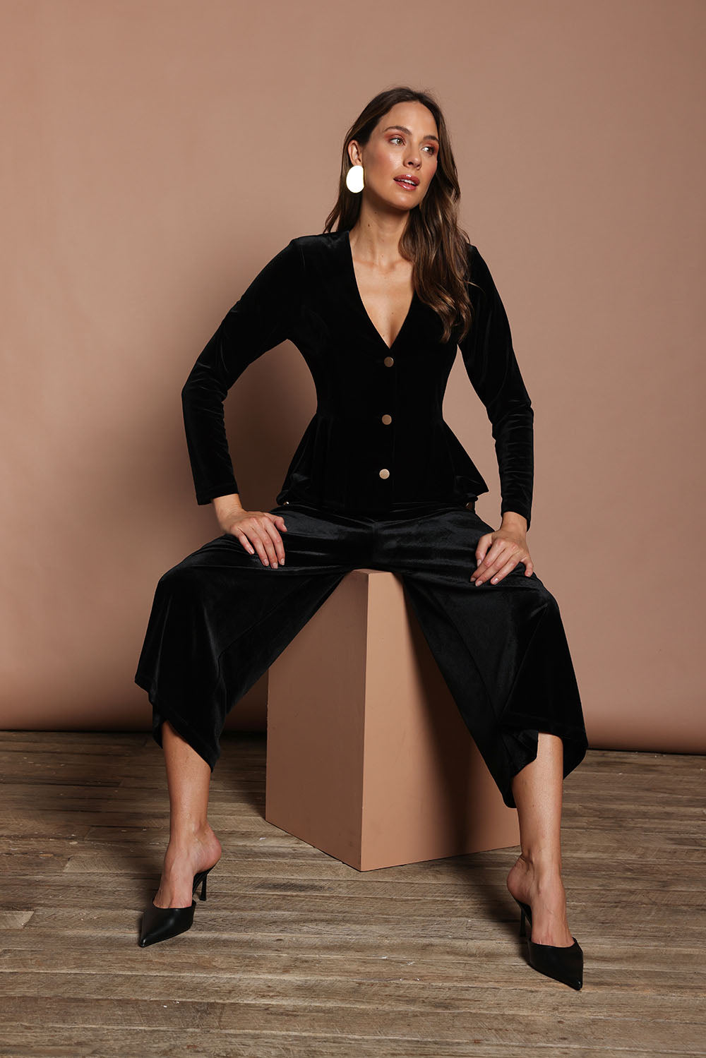 Model Madeline wearing size 10 of the Dawn Velvet Jacket in colour Black (Black), from the front, showing the whole outfit