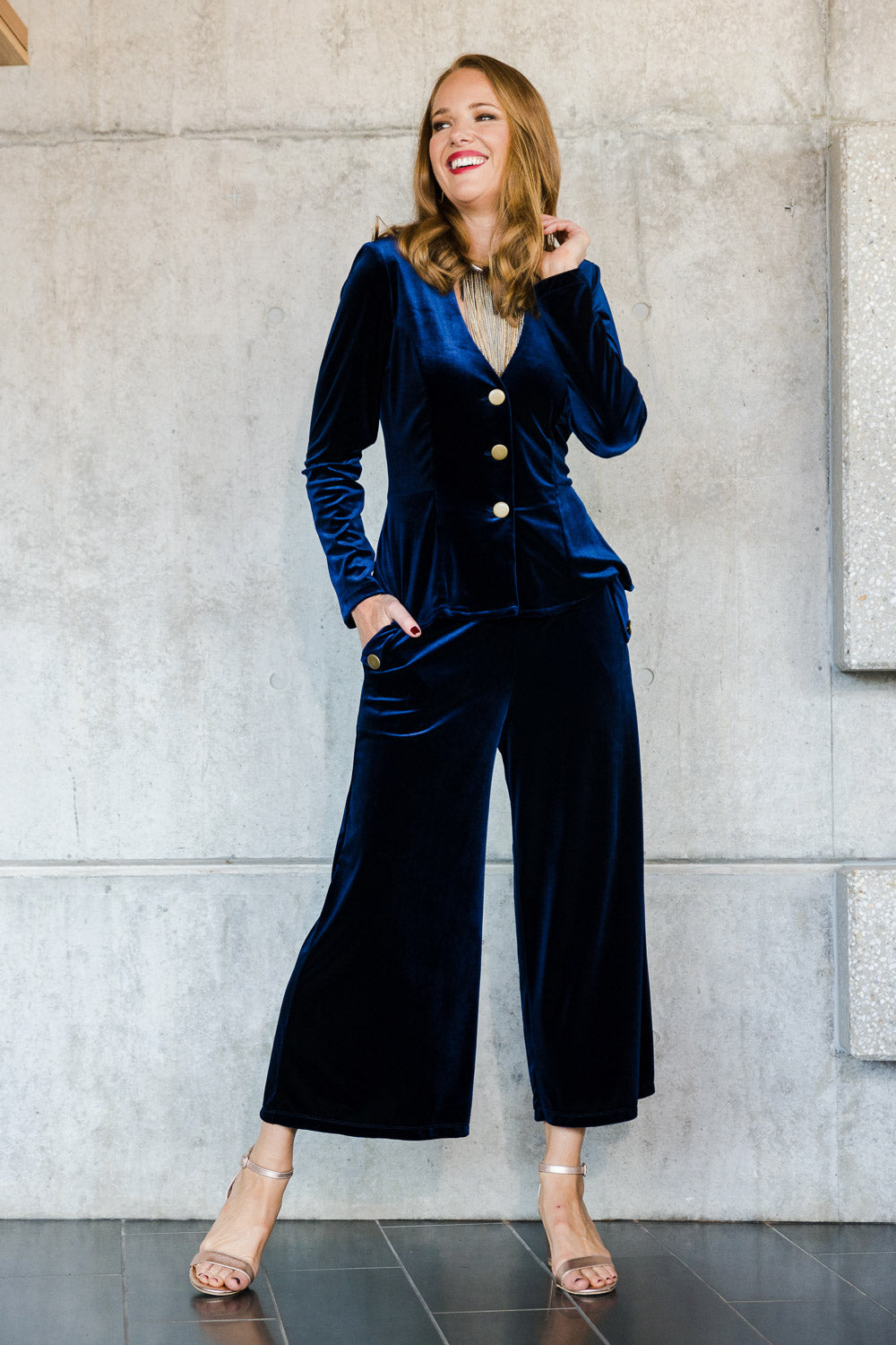 Model Katie wearing size 10 of the Dawn Velvet Jacket in colour Moonlight (Blue), from the front, showing the whole outfit
