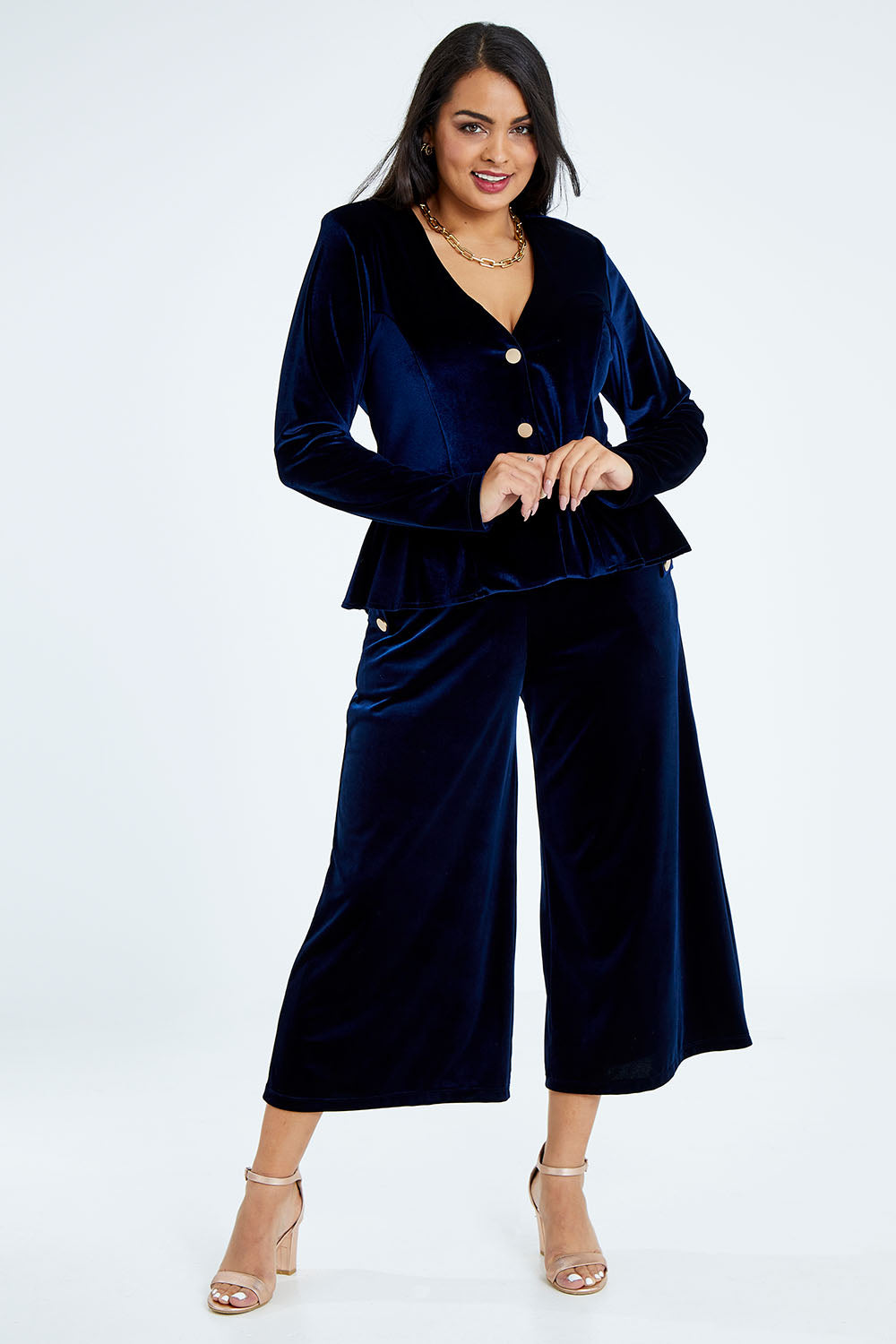 Model Sasha-Lee wearing size 16 of the Dawn Velvet Jacket in colour Moonlight (Blue), from the front, showing the whole outfit