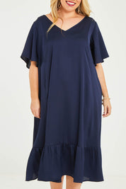 Model Katie wearing size 16 of the Mary Dress in colour Navy (Blue), from the front, cropped image
