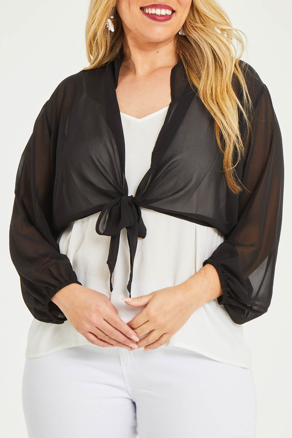 Model Katie wearing size 16 of the Penelope Shrug in colour Black (Black), from the front, cropped image