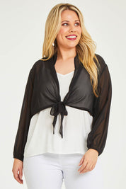Model Katie wearing size 16 of the Penelope Shrug in colour Black (Black), from the front, cropped image