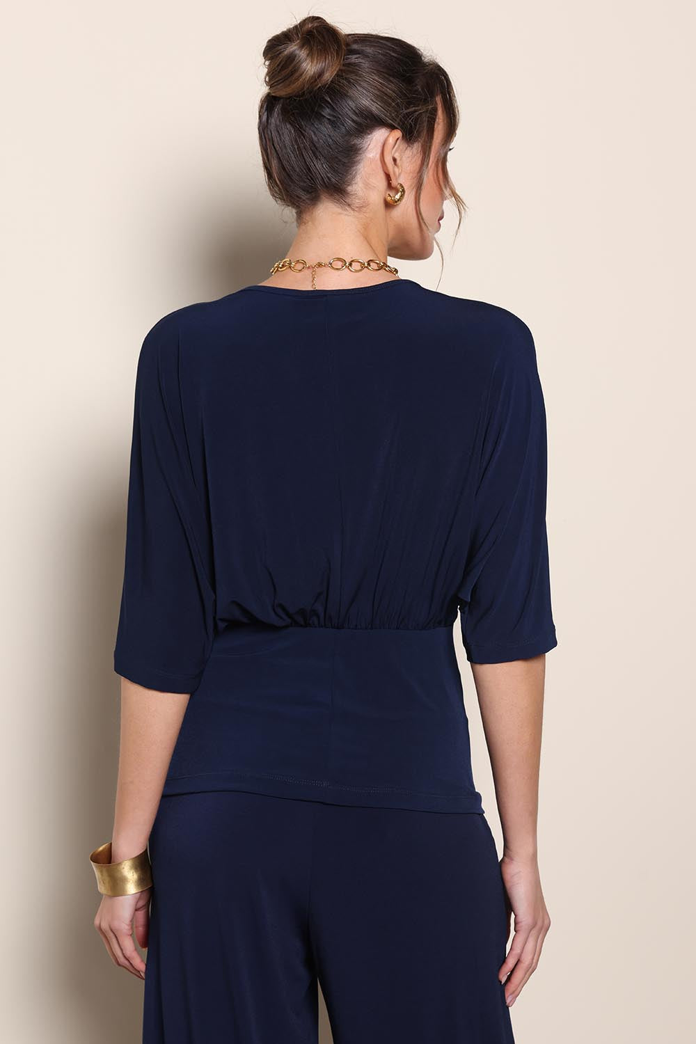 Model Maddiec wearing size 10 of the Niamh Top – Navy in colour Navy, from the back