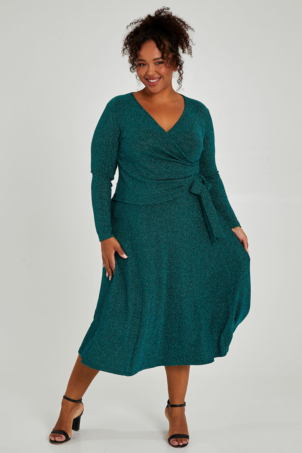 Model Alexis wearing size 16 of the Karen Skirt in colour Jade (Green), from the front, showing the whole outfit