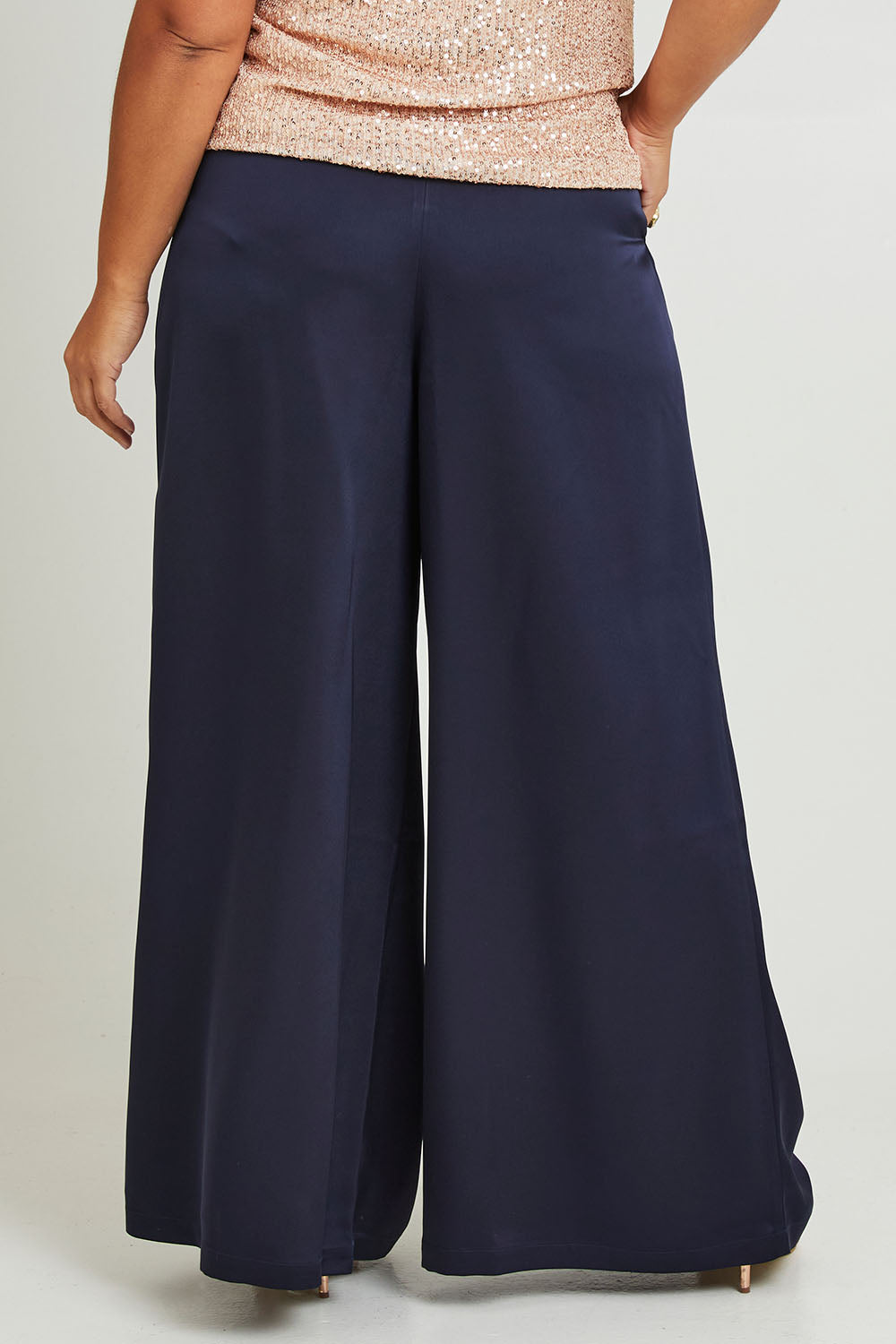 Model Ashleigh wearing size 16 of the Mandy Pants in colour Navy (Blue), from the back