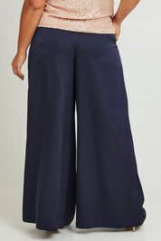 Model Ashleigh wearing size 16 of the Mandy Pants in colour Navy (Blue), from the back