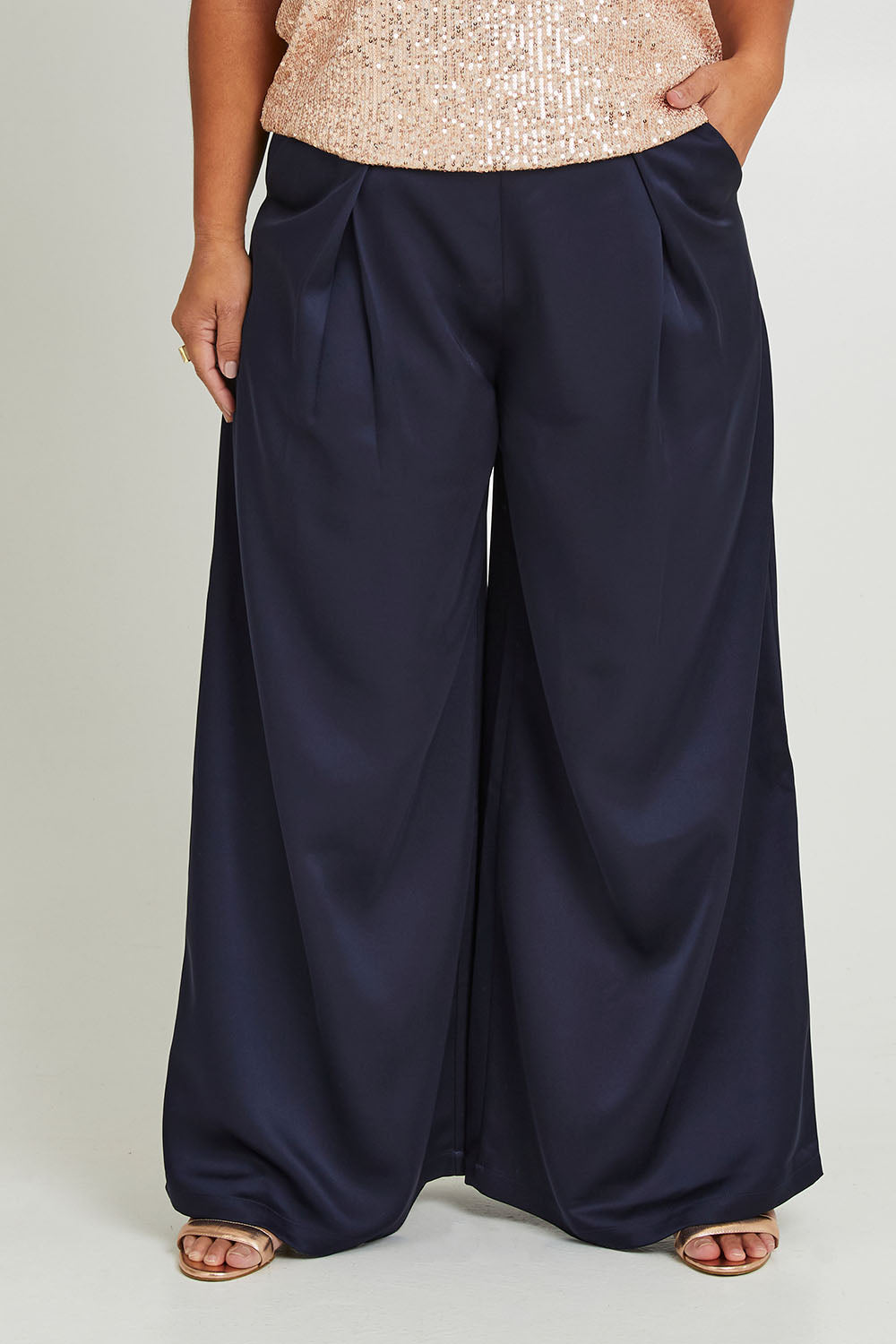 Model Ashleigh wearing size 16 of the Mandy Pants in colour Navy (Blue), from the front, cropped image