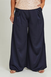 Model Ashleigh wearing size 16 of the Mandy Pants in colour Navy (Blue), from the front, cropped image