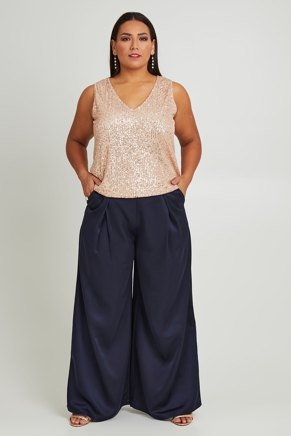 Model Ashleigh wearing size 16 of the Mandy Pants in colour Navy (Blue), from the front, showing the whole outfit