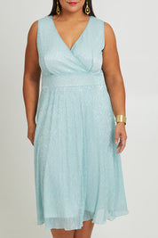 Model Ashleigh wearing size 16 of the Sally Ann Dress in colour Oasis (Green), from the front, cropped image