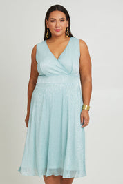 Model Ashleigh wearing size 16 of the Sally Ann Dress in colour Oasis (Green), from the front, cropped image
