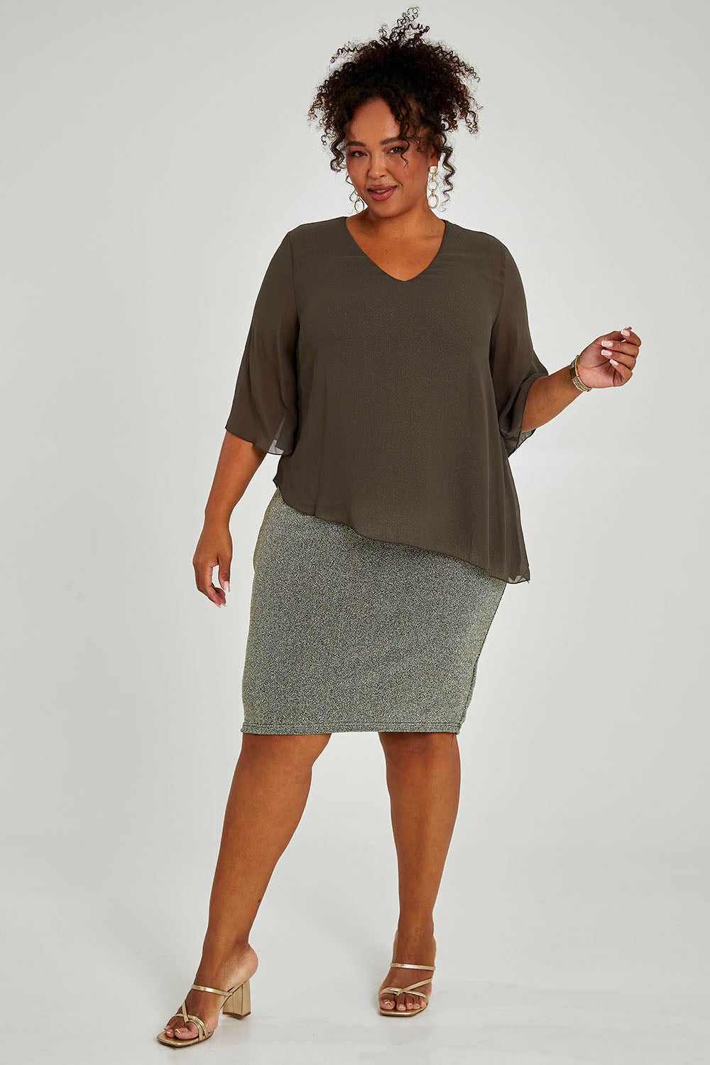 Model Alexis wearing size 16 of the Bridgette Dress in colour Khakisilv (Green), from the front, showing the whole outfit